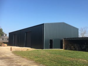 Large Anthracite coloured Industrial building with beautiful blue sky line
